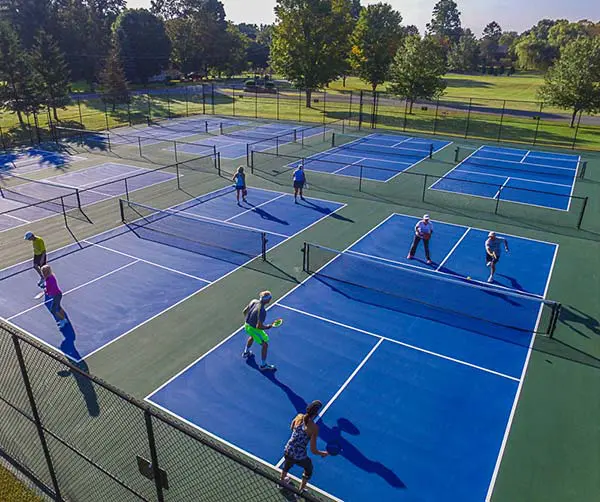 Overhead view of several pickleball courts with players